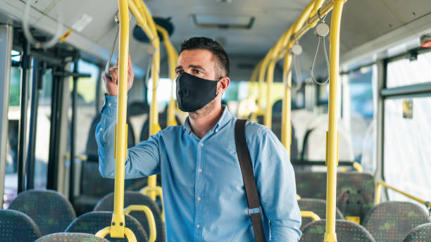 istock Men with protective face mask traveling with bus, during COVID-19 1303835863