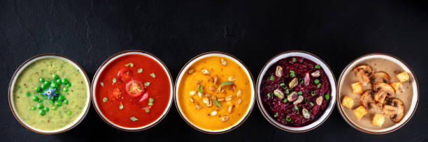 Vegan soup panoramic header with copyspace. Vegetable cream soups Vegan soup panoramic header with copyspace. Vegetable cream soups, shot from above on a black background pumpkin soup photos stock pictures, royalty-free photos & images