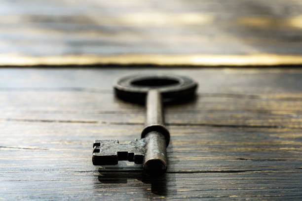istock Vintage key on wooden table 1303837494