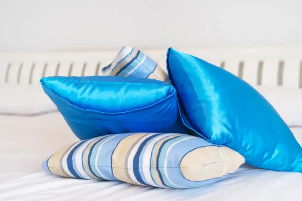 comfortable  blue pillows on white bed , close up , bedtime ,sleep concept