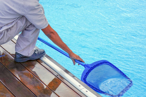 istock Hotel staff african worker cleaning the pool 1303839676