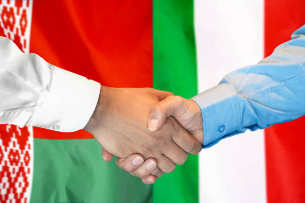 istock Handshake on Belarus and Italy flag background. Support concept. 1303840237