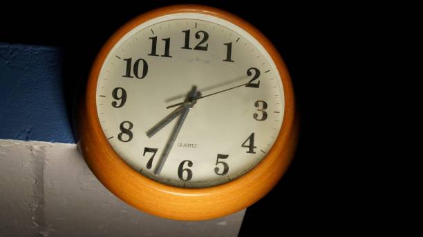 White clock to show time and daily routine life. Timepiece wall watch with numeral numbers and needles closeup. stock photo