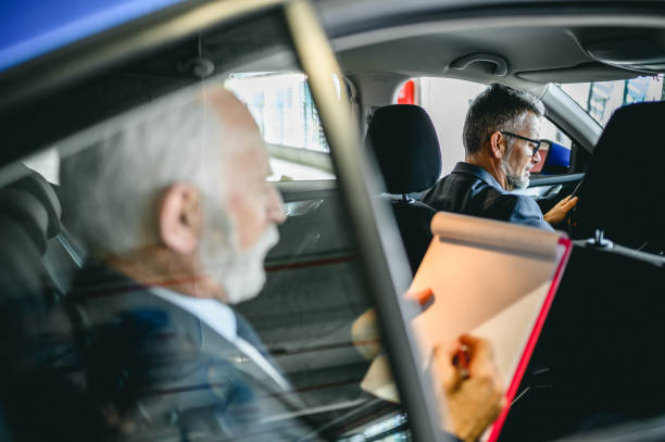 istock Chauffeur driven car with the businessman in the back seat 1303840935