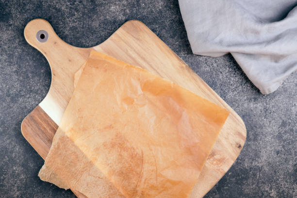 istock Wooden plate on dark rustic background top view 1303841181