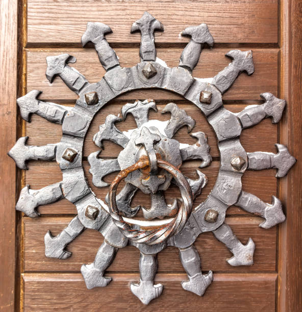 istock Forged sun and an old doorknob. Medieval decor 1303842105
