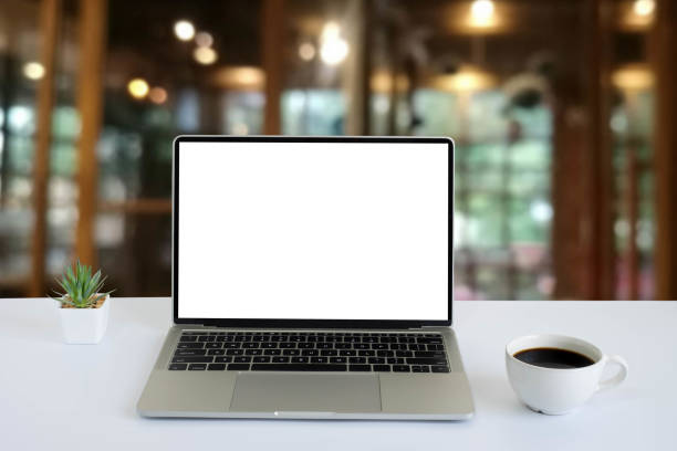 istock Front view of open laptop computer notebook with blank monitor white screen display on work table desk. Workspace office modern for job business online communication technology in shop or home indoor. 1303844093