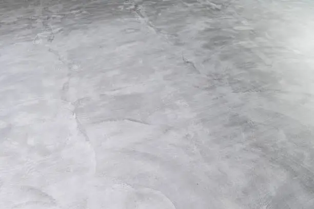 Background of Microcement grey floor with defects due to human errors. Construction industry