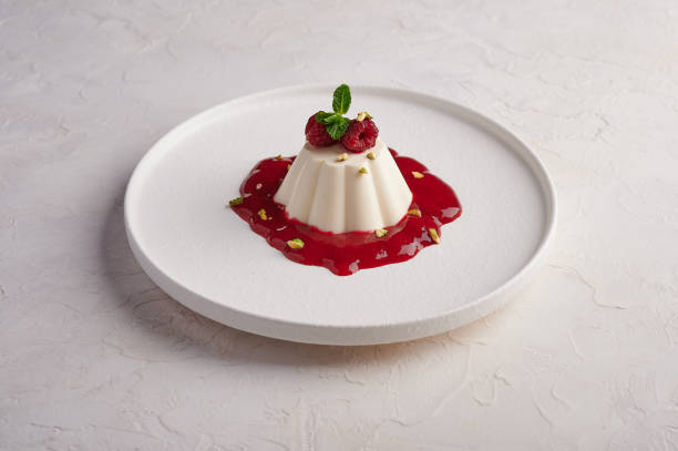 istock Panna cotta with raspberry syrup, pistachios,berries and mint 1303849549