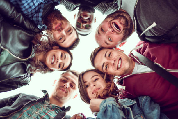 Smiling Faces Of Happy Friends Peering Down Together