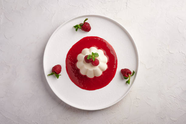 Panna cotta with raspberry syrup, pistachios,berries and mint
