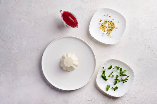 ngredients for panna cotta with raspberry syrup, pistachios,berries and mint