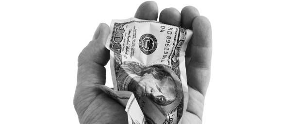 istock A crumpled hundred-dollar cash bill in his hand. 1303851092