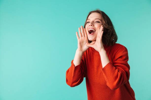 istock Screaming woman standing isolated over blue background 1303851381