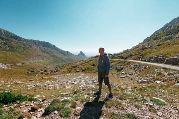 istock Man hiking in mountains in summer 1303852376