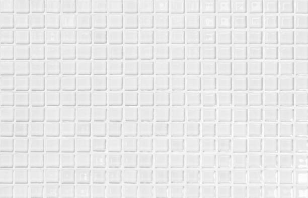 istock White or gray ceramic wall and floor tiles abstract background. Design geometric mosaic texture decoration of the bedroom. Simple seamless pattern for backdrop hospital wall, canteen and grid paper. 1303852748