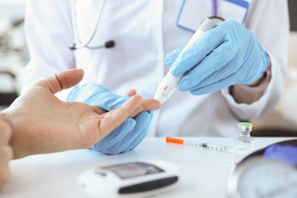 Doctor with gloves piercing patients finger with lancet closeup Doctor with gloves piercing patients finger with lancet closeup. Blood glucose monitoring concept cholesterol screening stock pictures, royalty-free photos & images