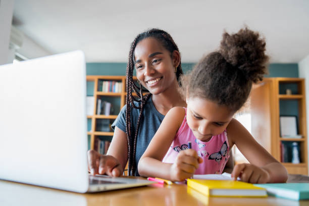 istock A mother helping her daughter with homeschool. 1303855696
