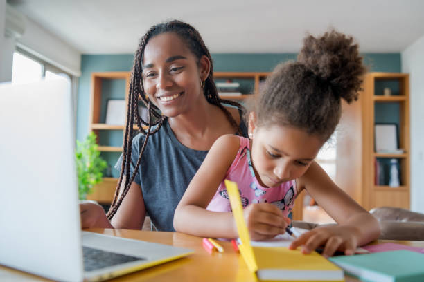 istock A mother helping her daughter with homeschool. 1303855699