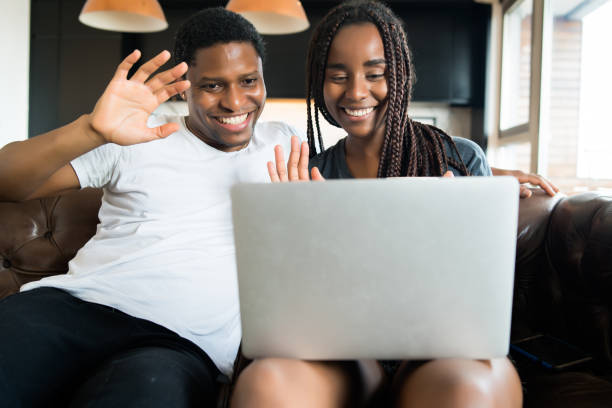 istock Couple on a video call with laptop at home. 1303855734