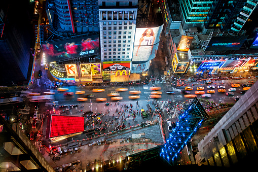 New York, USA - June 29th, 2014: Aerial view of Times Square the popular New Year's Eve destination with crowds and taxi cabs in motion in New York City