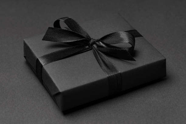 istock Black Gift box close up on dark background 1303858894