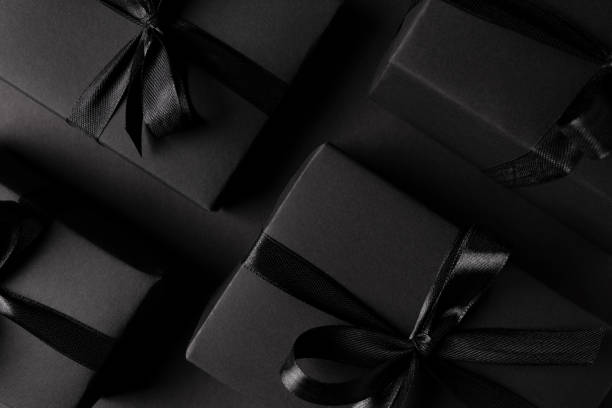 istock Black Gift boxes close up on dark background 1303860018