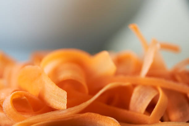 A photo of fresh carrot slices can be used as a background
