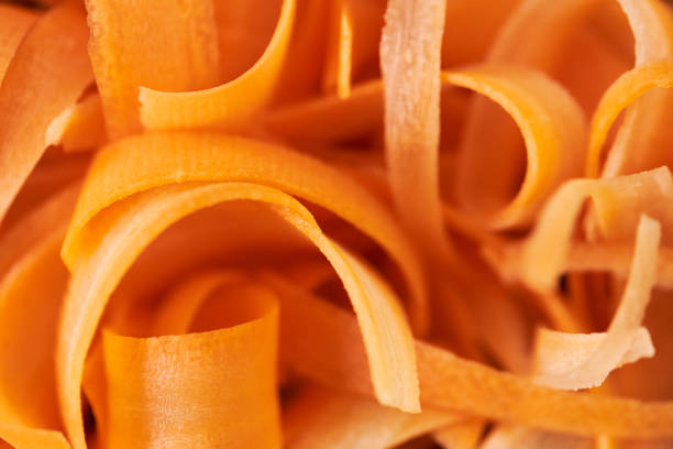 A photo of fresh carrot slices can be used as a background