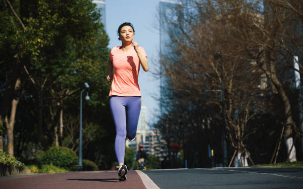istock Woman running outdoors in the city 1303864721