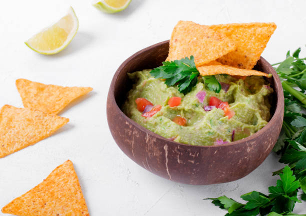 istock Guacamole dip in a wooden bowl 1303865424