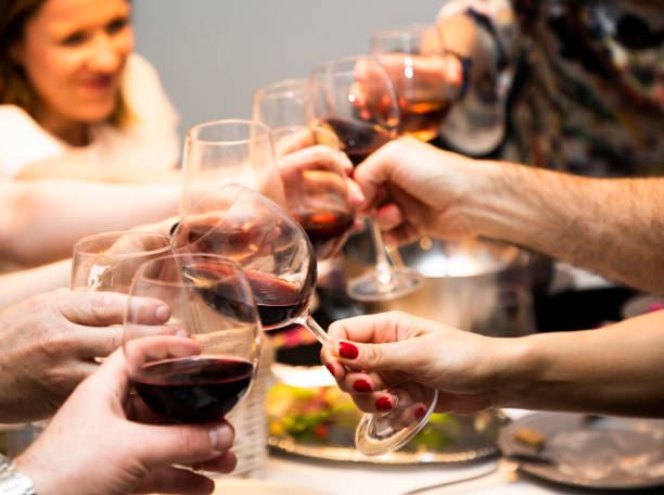 istock Group of people making celebratory toast with wine 1303867023