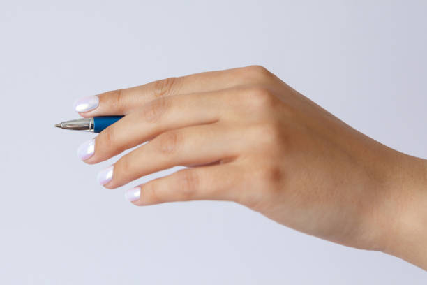 istock Gesture and sign, hand holding a pen on a white background 1303867600