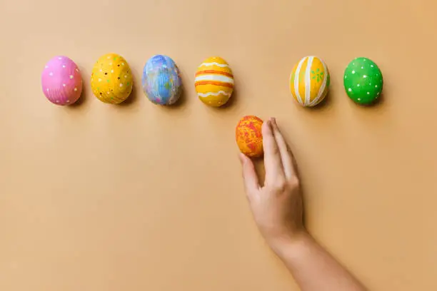 Colorful easter wooden eggs in child hands after egg-hunt