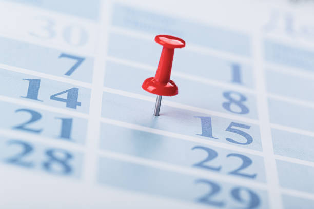 istock Embroidered red pins on a calendar  with selective focus 1303870249