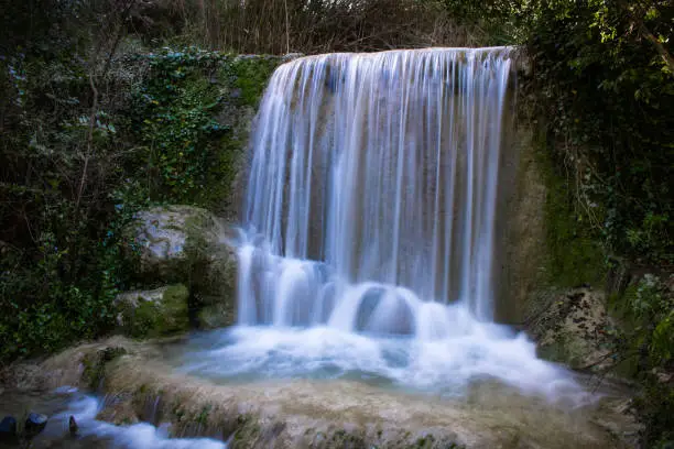 Waterfall of Quiaios in Portugal, also known as Cascata de Quiaios near Figueira da Foz, a beautiful and peaceful natural hidden spot in the woods. Long exposure photo of small cascade