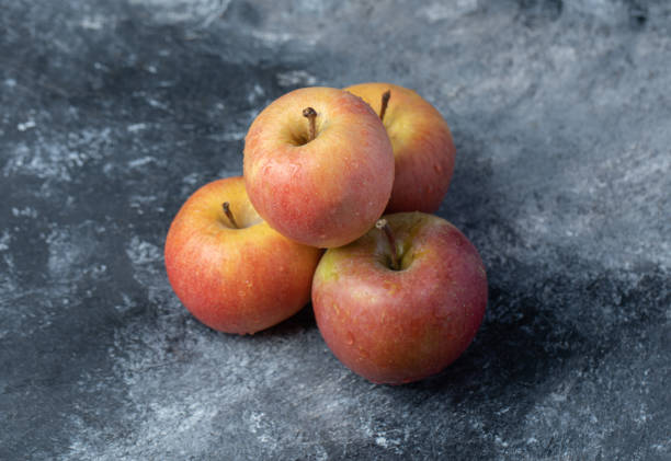 istock Set of fresh red yellow apple on marble background 1303870825
