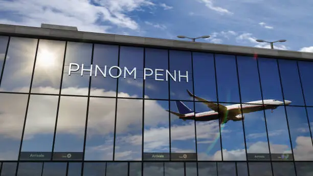 Photo of Airplane landing at Phnom Penh Cambodia airport mirrored in terminal