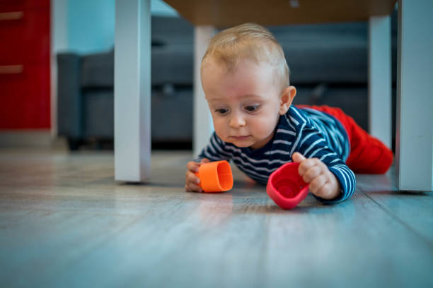 istock Happy baby playing with toy blocks 1303874659