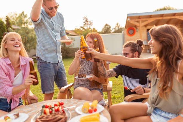 istock People drinking beer at backyard barbecue party 1303875835