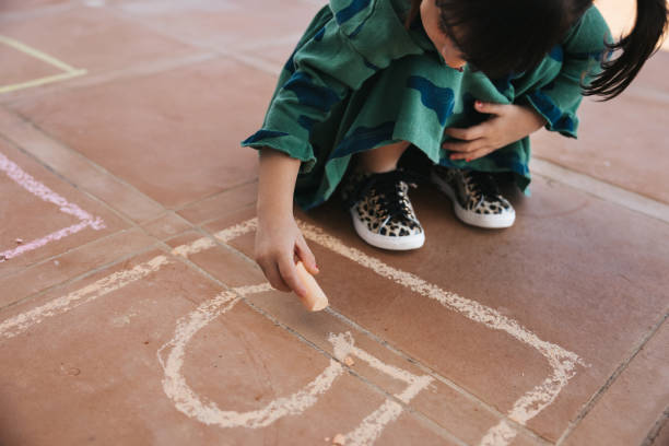 istock Kids playing hopscotch 1303876034
