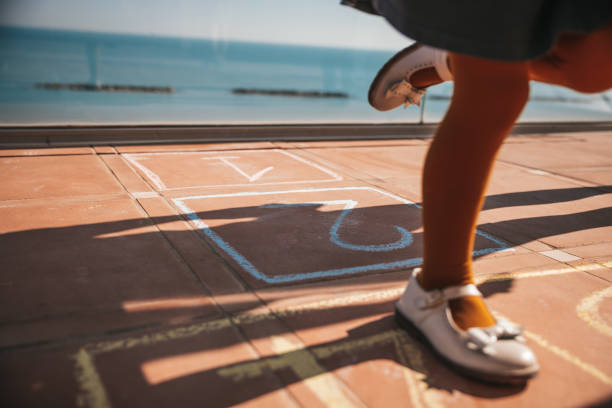 istock Kids playing hopscotch 1303876161