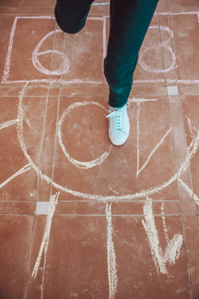istock Kids playing hopscotch 1303876848