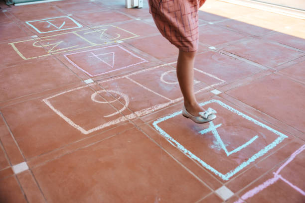 istock Kids playing hopscotch 1303877198
