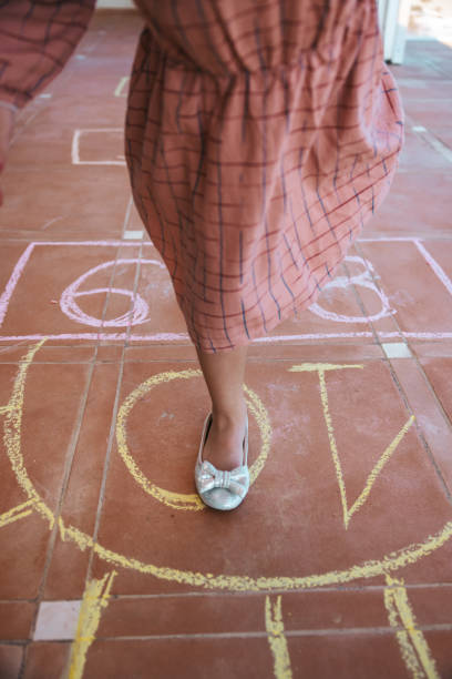 istock Kids playing hopscotch 1303877239