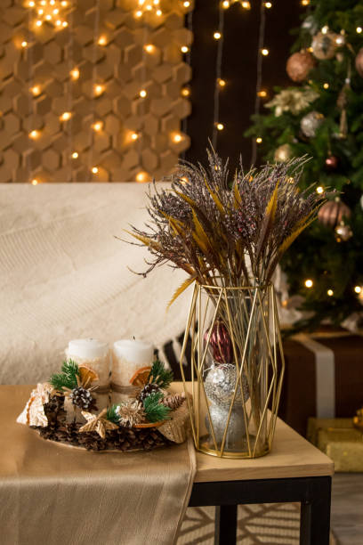 istock New Year's composition on the table. Cones, candles, spruce branches, bouquet 1303877249