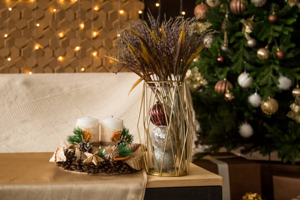 istock New Year's composition on the table. Cones, candles, spruce branches, bouquet 1303877255