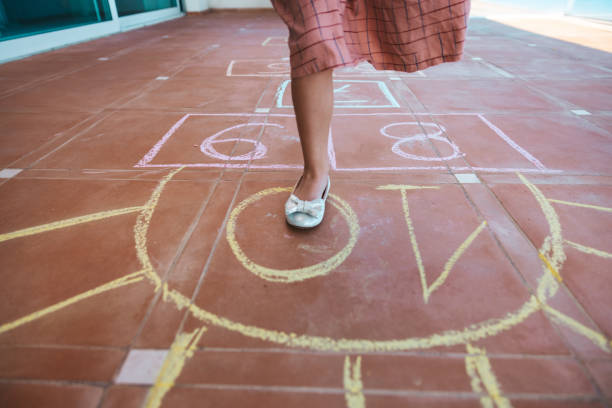 istock Kids playing hopscotch 1303877716