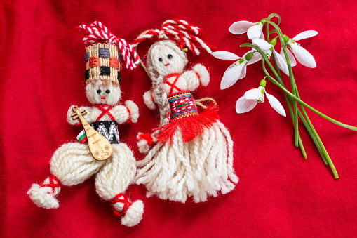 Martenitsa - traditional Bulgarian custom - red background with snowdrops