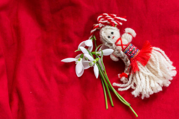 istock Martenitsa - traditional Bulgarian custom - red background with snowdrops 1303877786